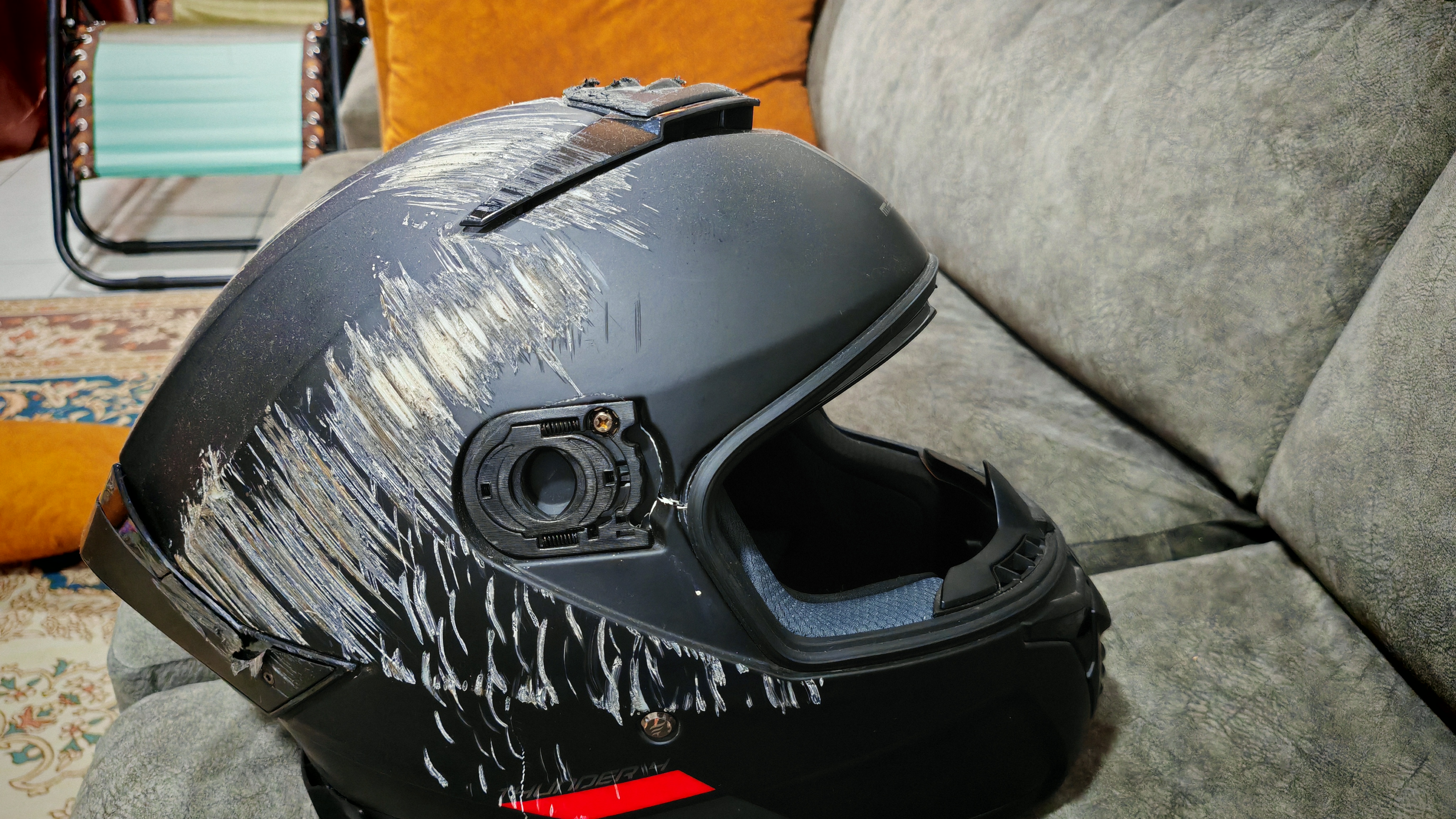 Scratched up pretty good. Visor gone. You can see the crack on the shell near where my temple would be.